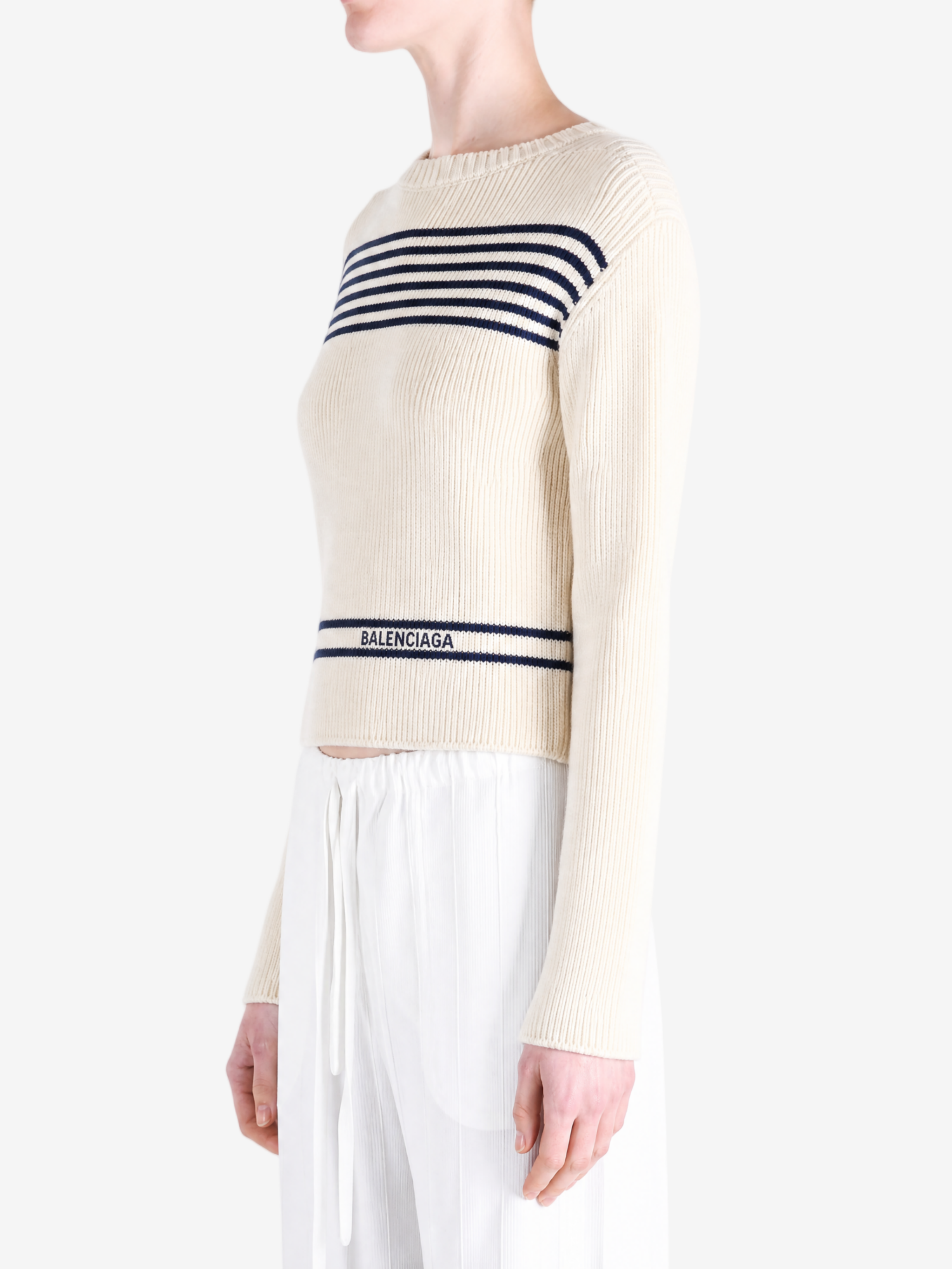 Tan knitwear worn by a person, showing the knitwear fit