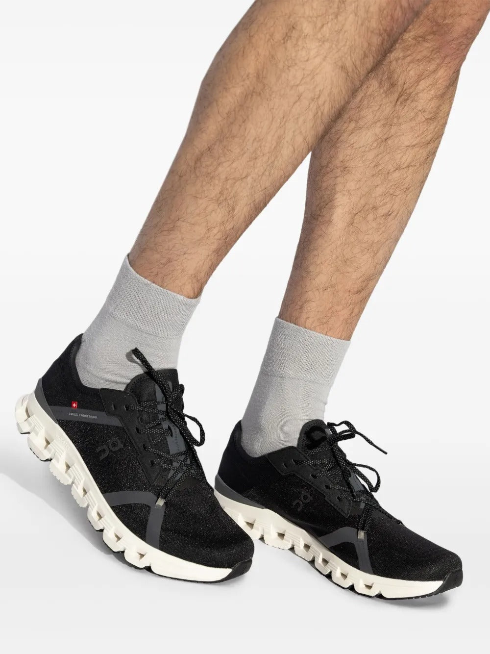 Black sneaker worn by a person, showing the sneaker's fit