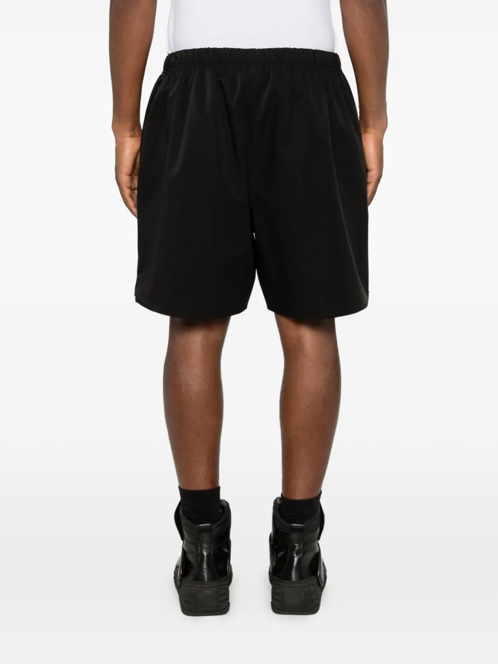 Black shorts worn by a person, showing the shorts fit