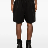 Black shorts worn by a person, showing the shorts fit