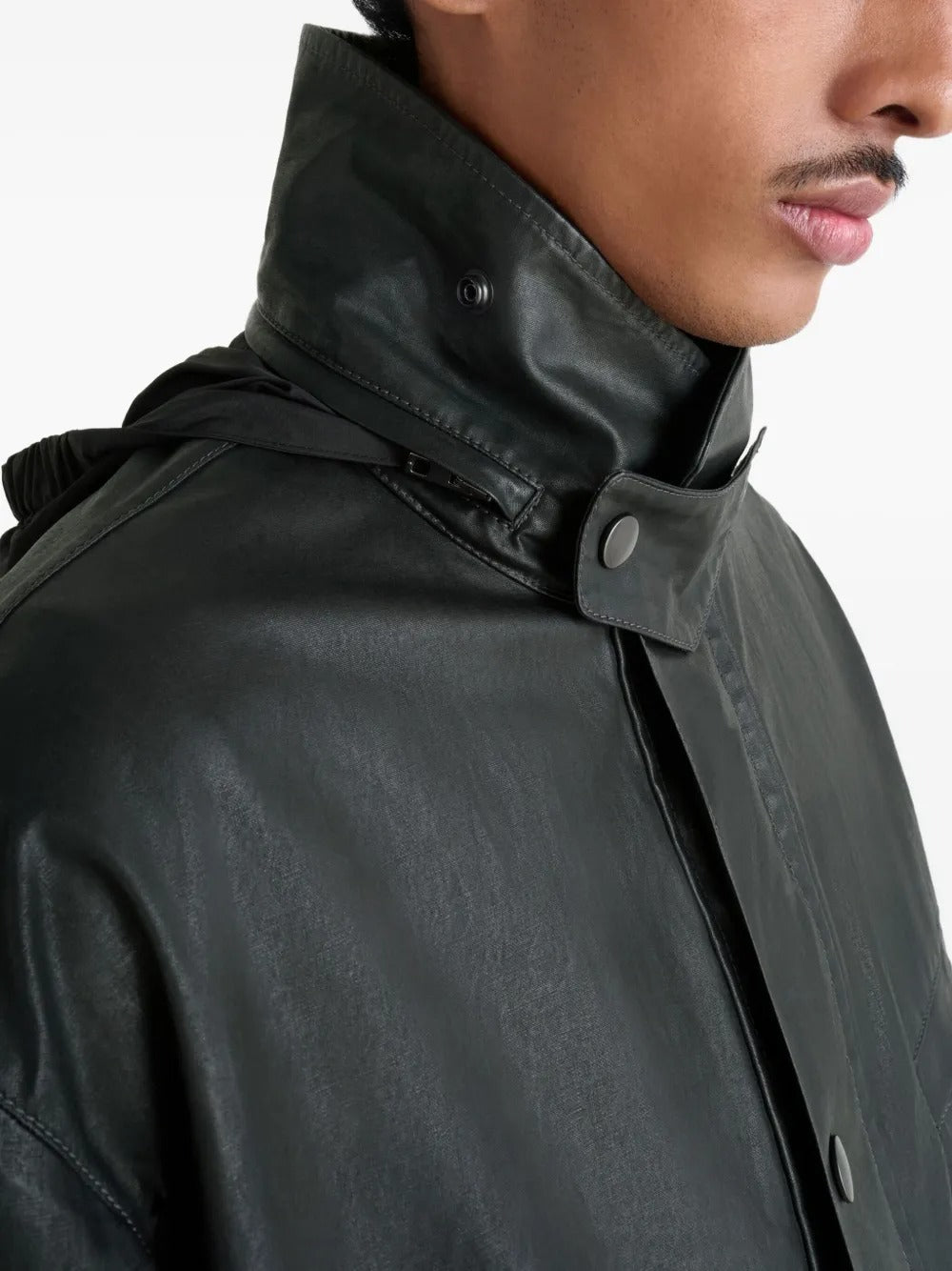 Close up of the black jacket, showing texture of the leather fabric