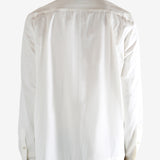 White shirt worn by a person, showing the shirt's fit