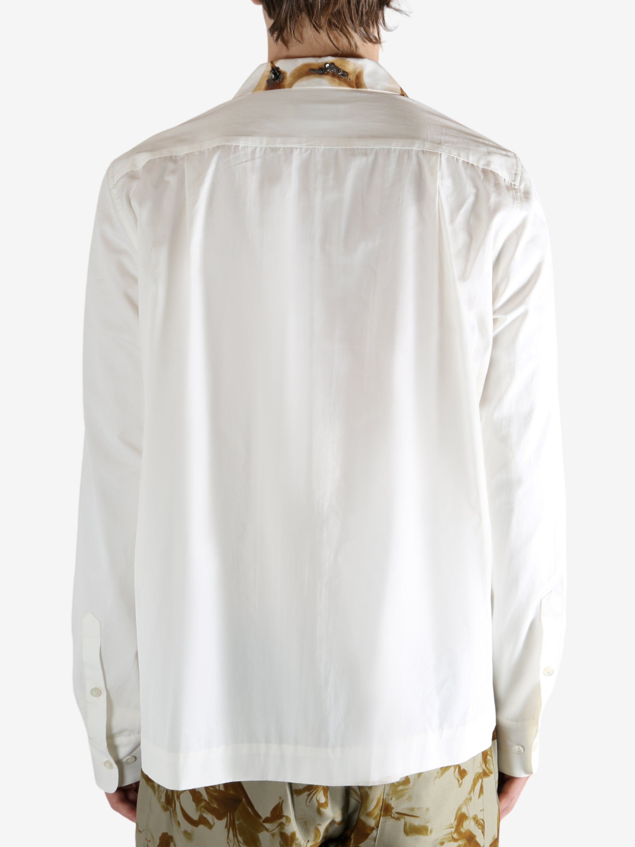 White shirt worn by a person, showing the shirt's fit