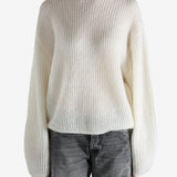 beige sweater worn by a person, showing the sweater fit