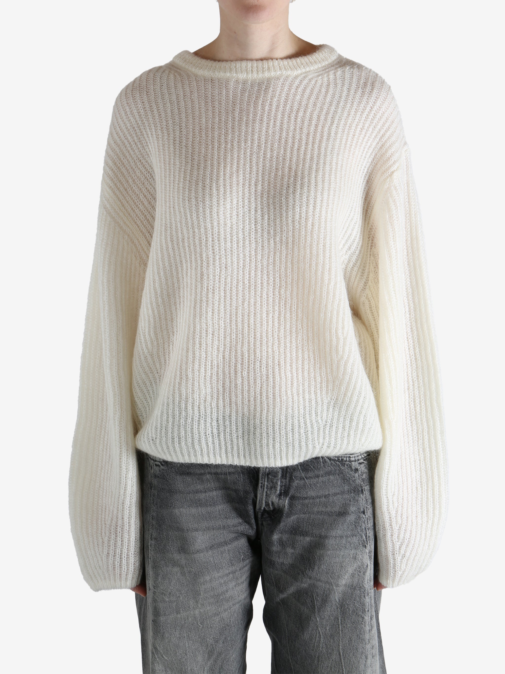 beige sweater worn by a person, showing the sweater fit