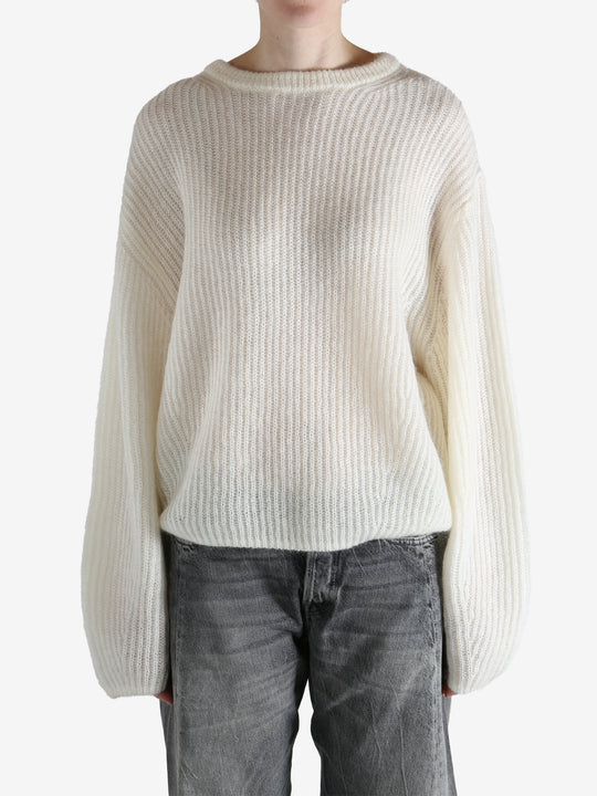 beige sweater worn by a person, showing the sweater fit