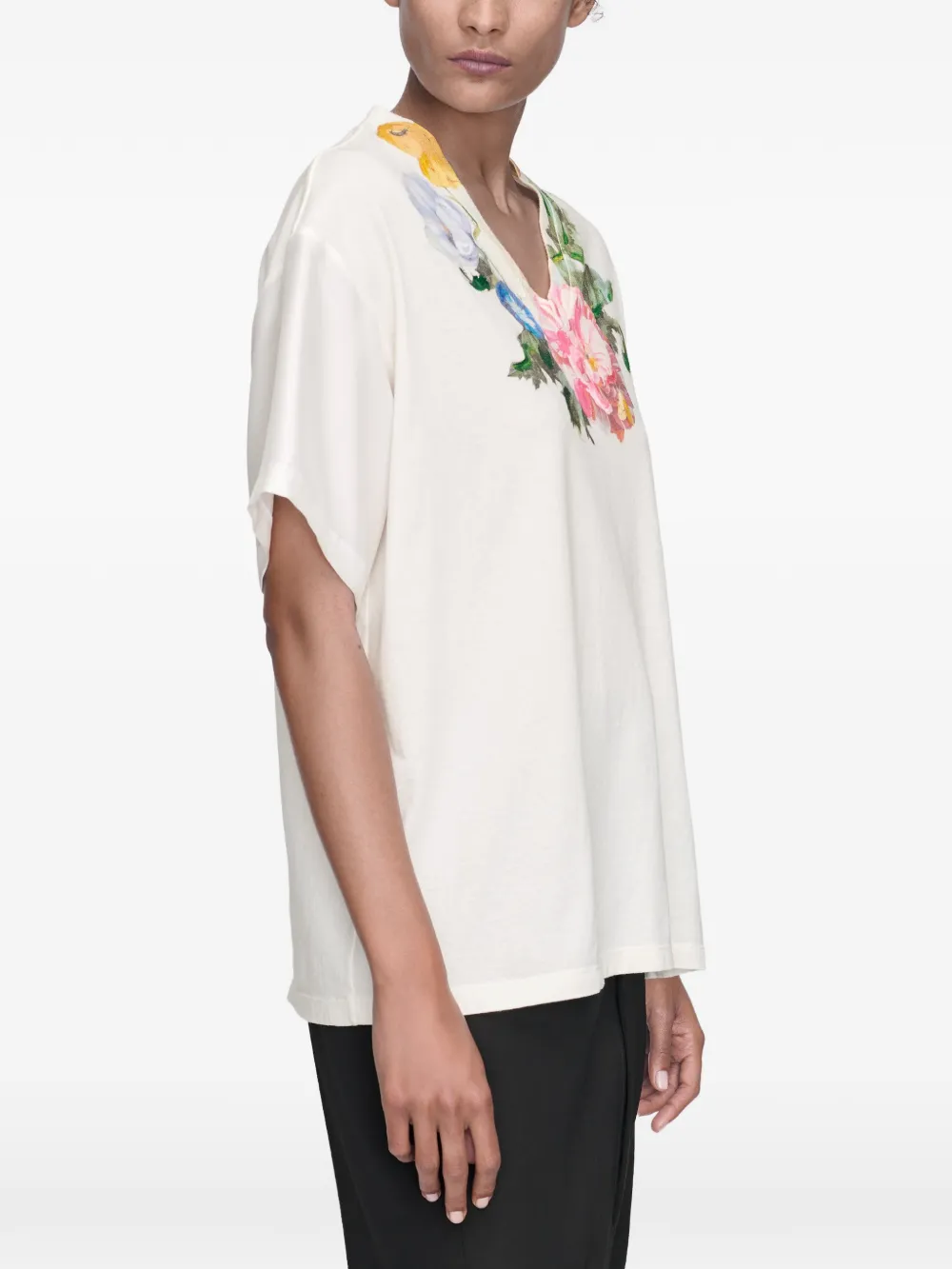 White t-shirt worn by a person, showing the t-shirt's fit