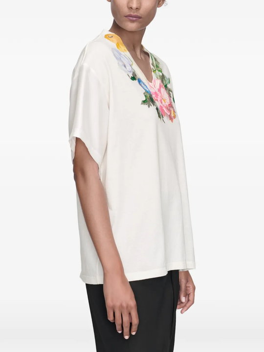 White t-shirt worn by a person, showing the t-shirt's fit