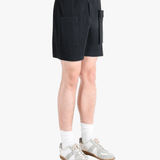 Black pants worn by a person, showing the pants fit
