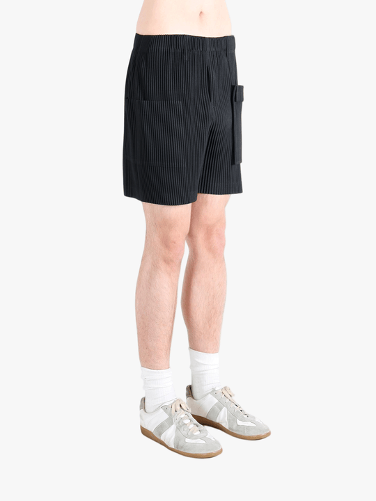 Black pants worn by a person, showing the pants fit