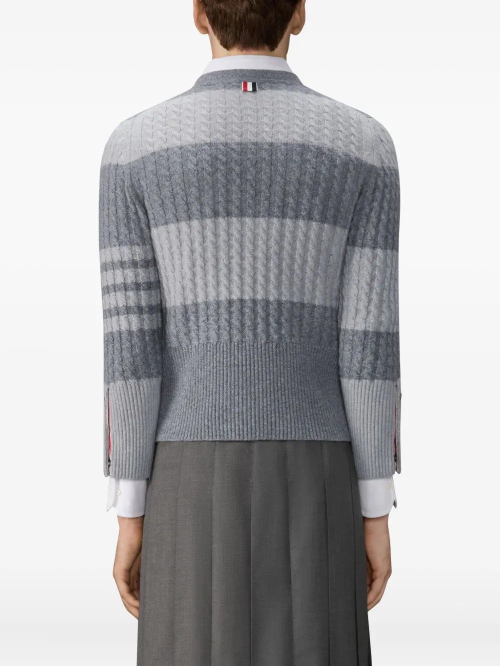 Grey knitwear worn by a person, showing the knitwear fit