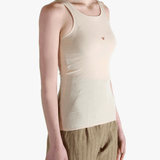 White top worn by a person, showing the top's fit