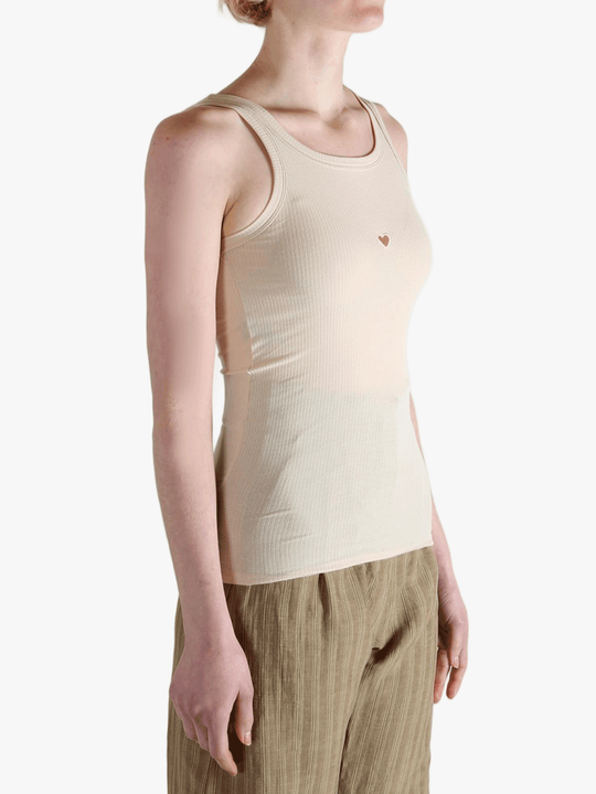 White top worn by a person, showing the top's fit