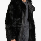 Black coat worn by a person, showing the coat's fit