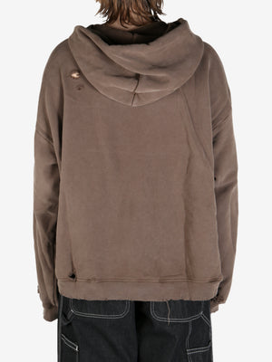 Brown sweatshirt worn by a person, showing the sweatshirt fit