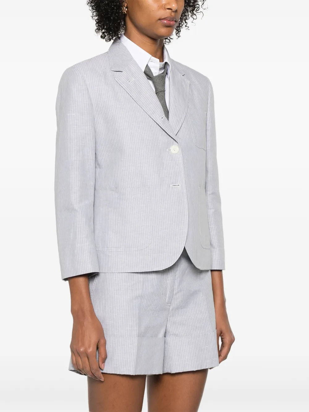 Grey jacket worn by a person, showing the jacket fit