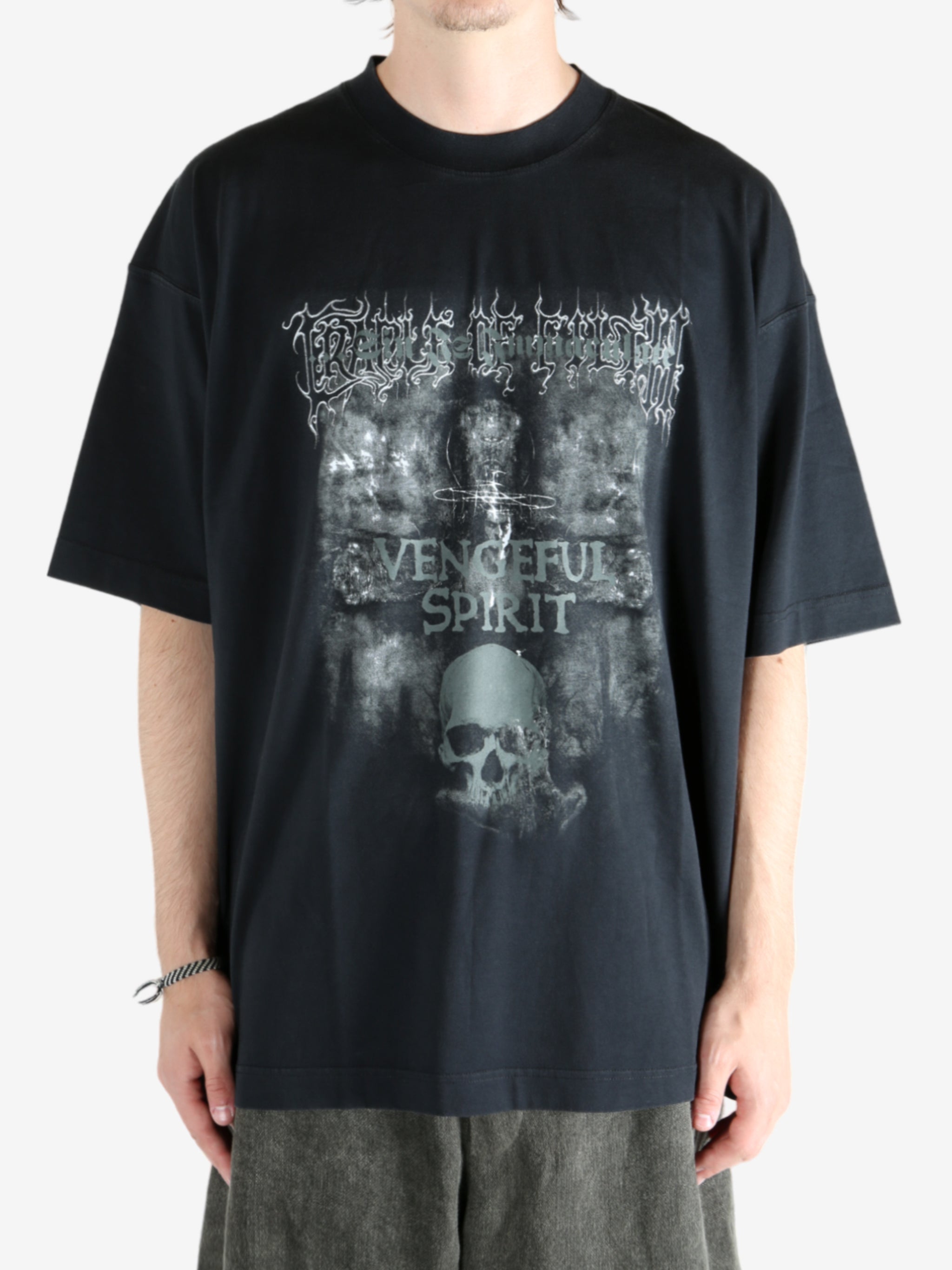 Black shirt worn by a person, showing the shirt fit