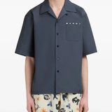 Blue shirt worn by a person, showing the shirt fit