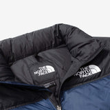 Close up of navy jacket, showing texture of the nylon fabric