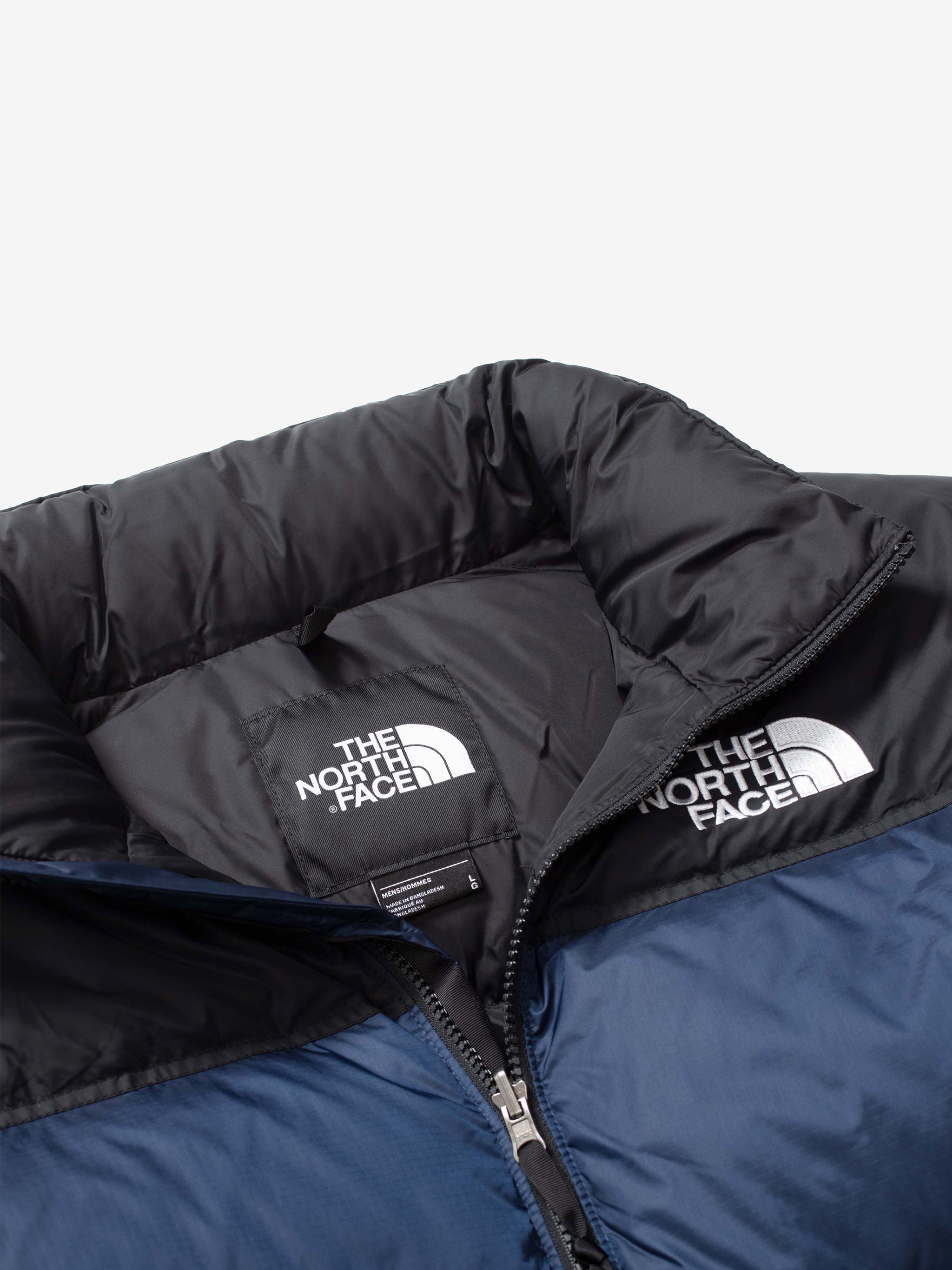 Close up of navy jacket, showing texture of the nylon fabric