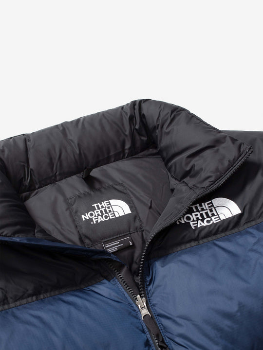 Close up of navy jacket, showing texture of the nylon fabric