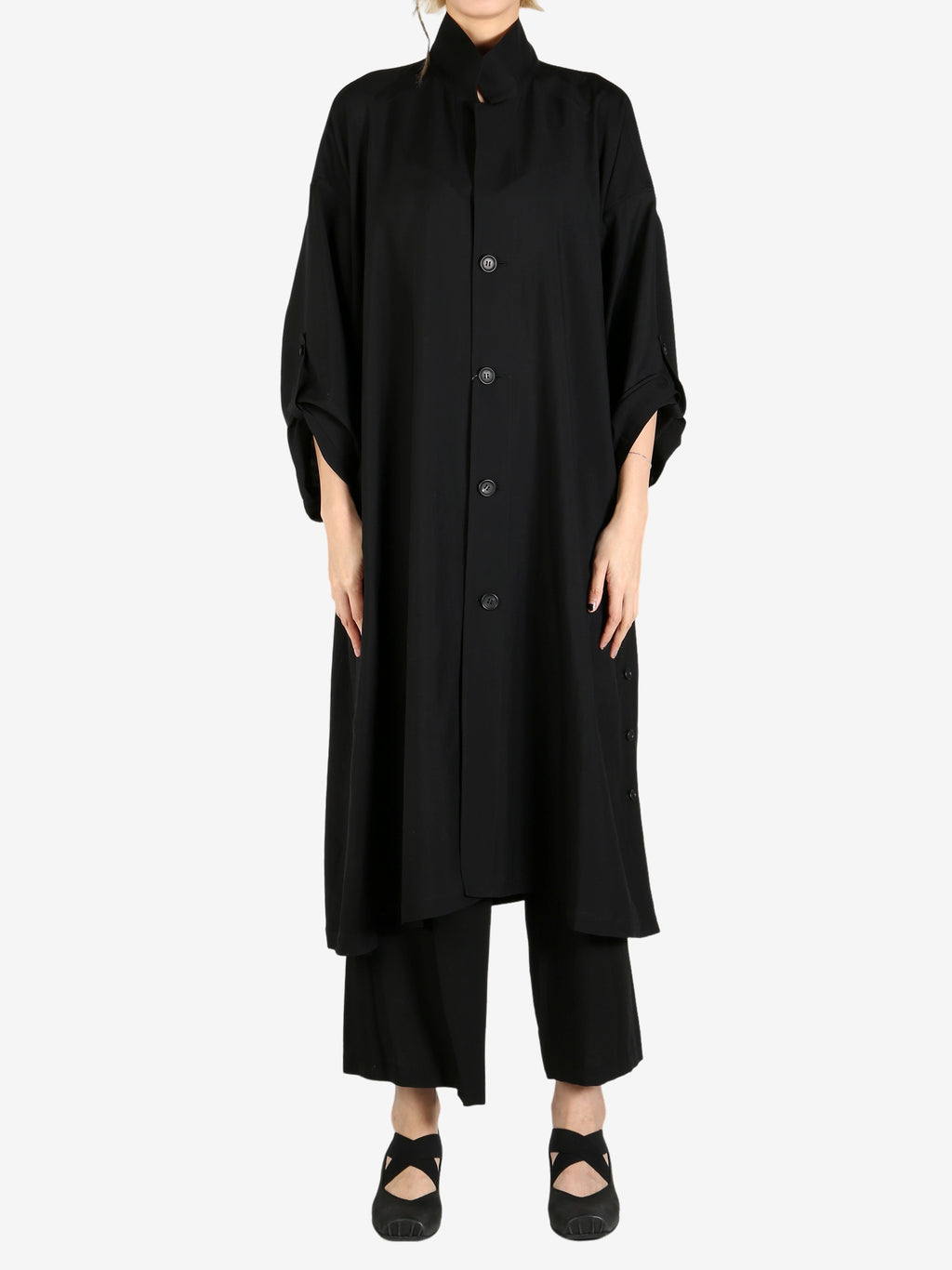 Black coat worn by a person, showing the coat’s fit