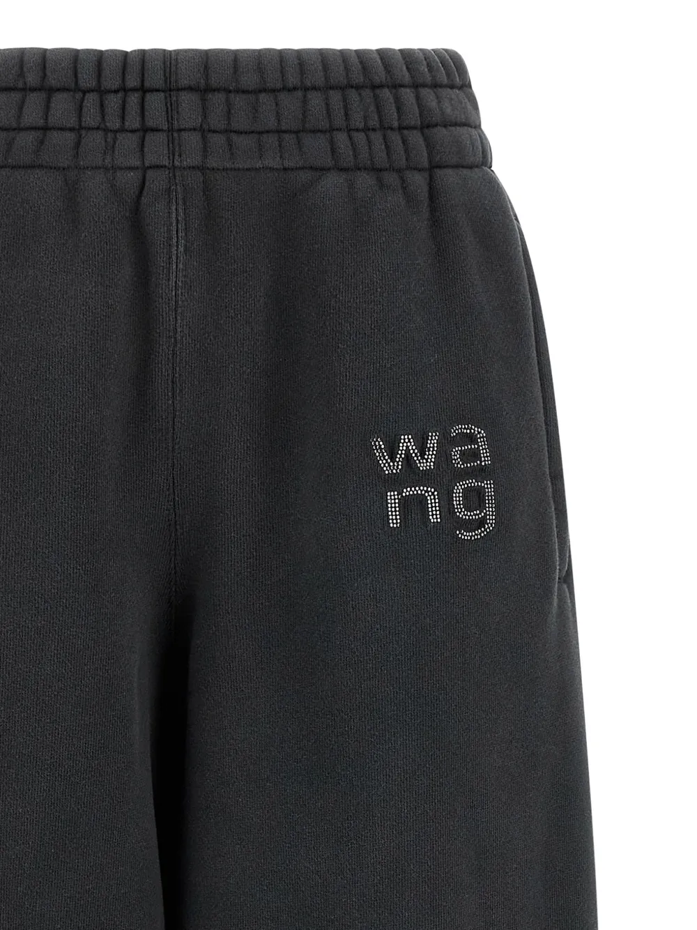 Close up of black pants, showing texture of the Logo rhinestones