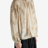 Tan knitwear worn by a person, showing the knitwear's fit