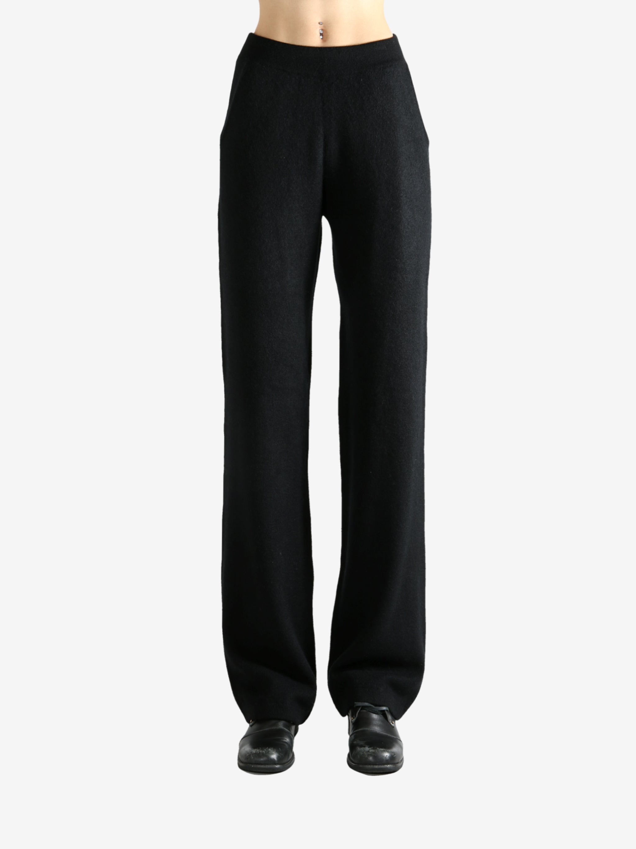 Black pants worn by a person, showing the pants' fit