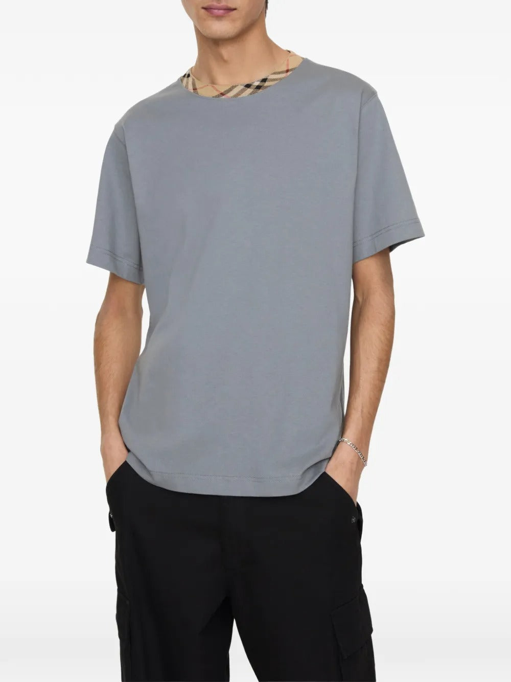 Grey shirt worn by a person, showing the shirt's fit