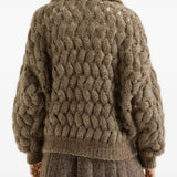 Brown knitwear worn by a person, showing the knitwear fit