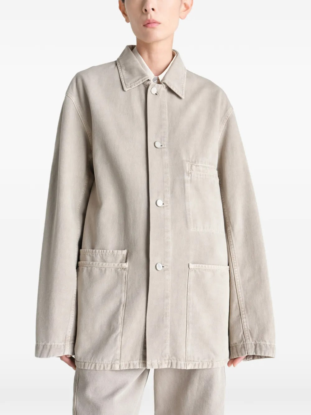 White shirt worn by a person, showing the shirt's fit