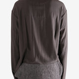 Brown long-sleeve shirt worn by a person, showing the shirt's fit