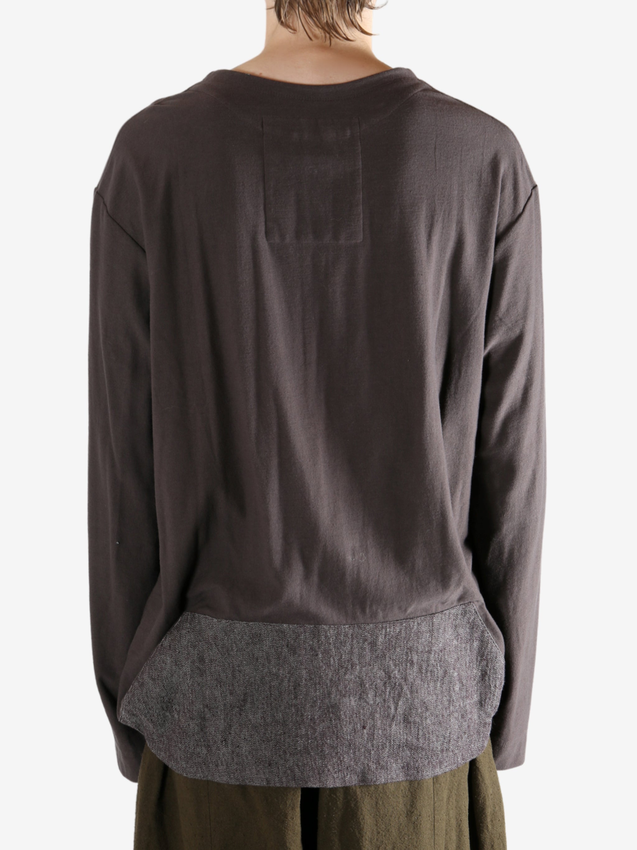 Brown long-sleeve shirt worn by a person, showing the shirt's fit