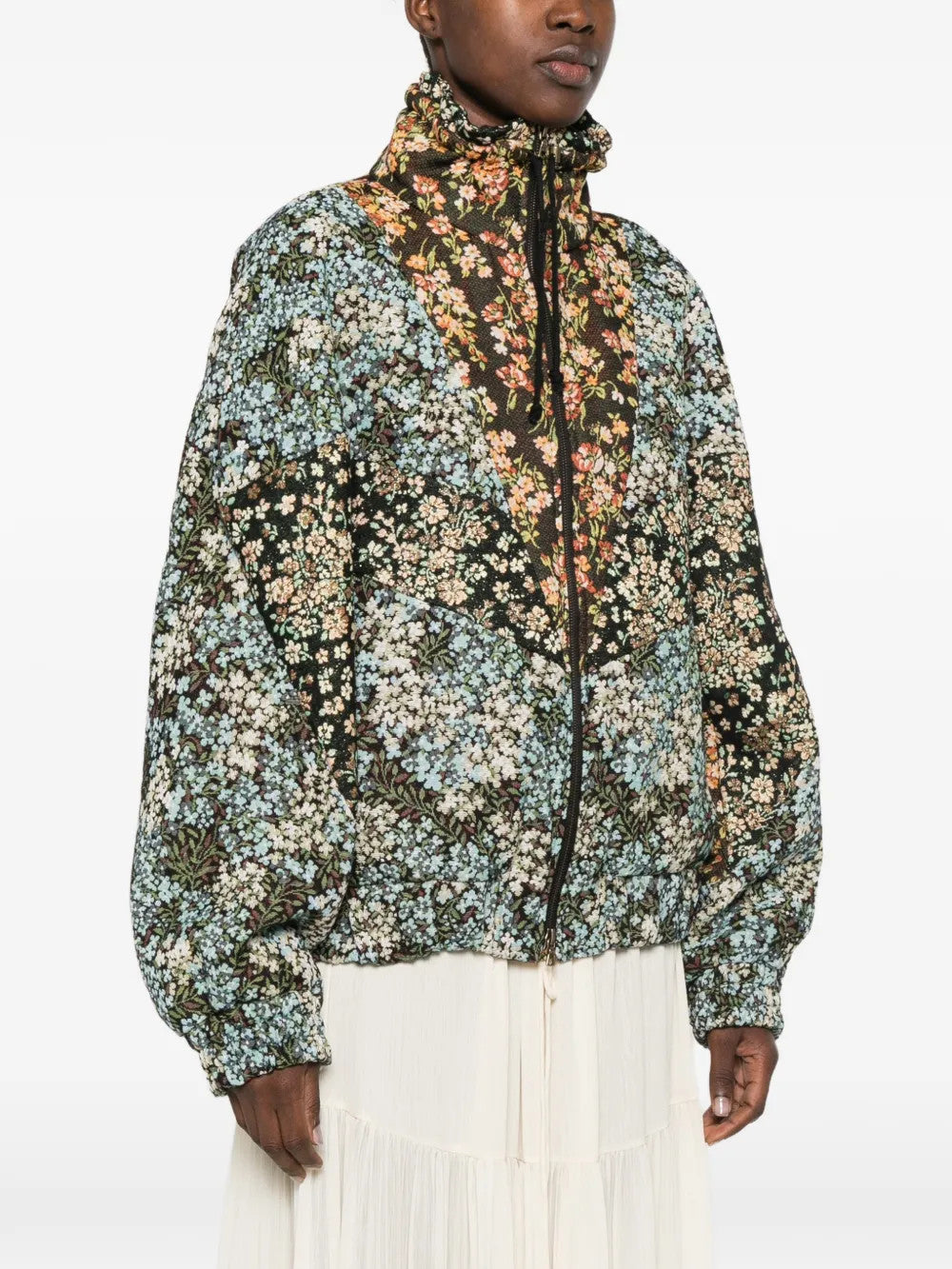 Green jacket worn by a person, showing the jacket fit