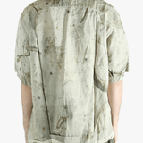 Green shirt worn by a person, showing the shirt's fit