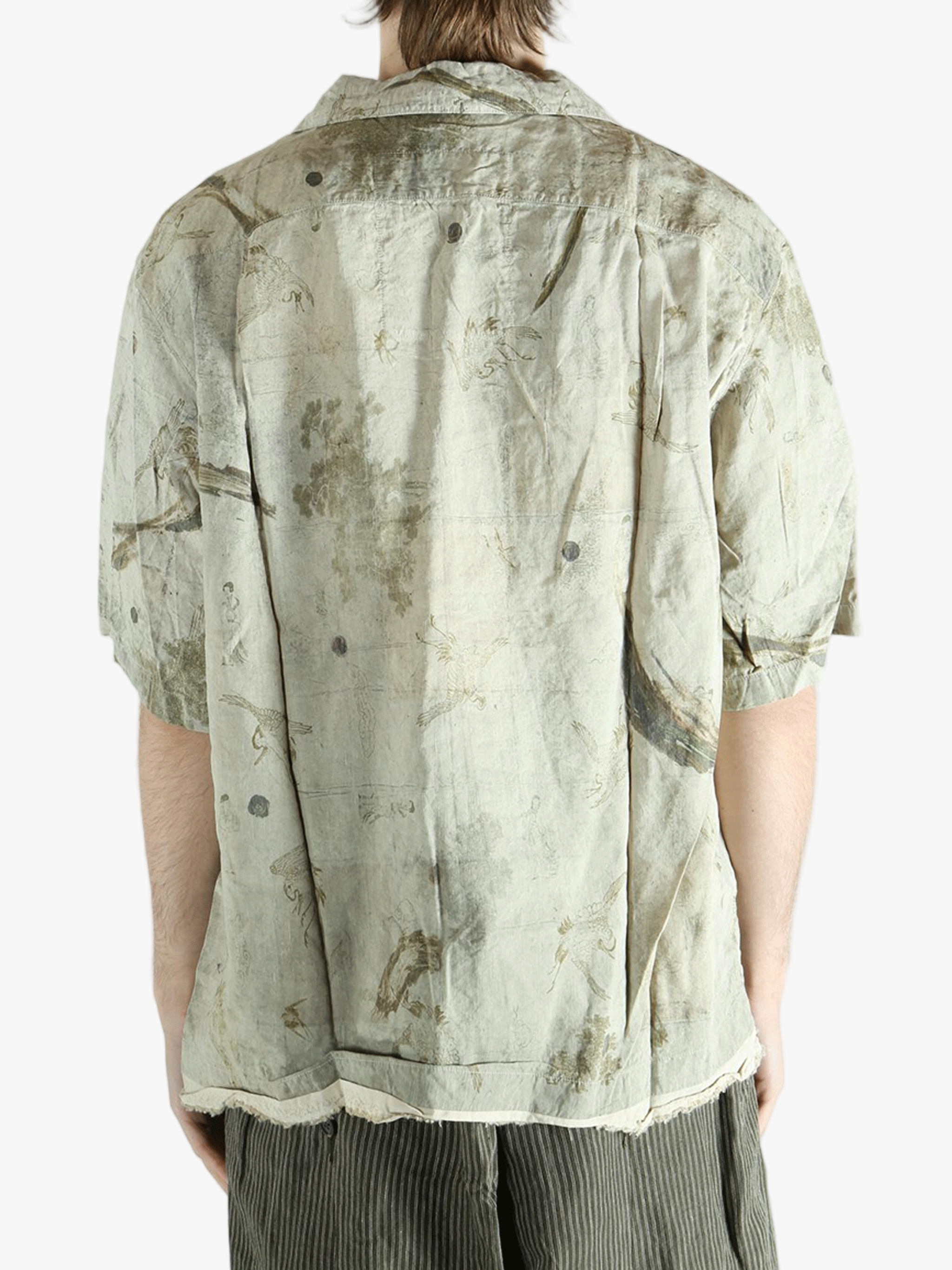 Green shirt worn by a person, showing the shirt's fit