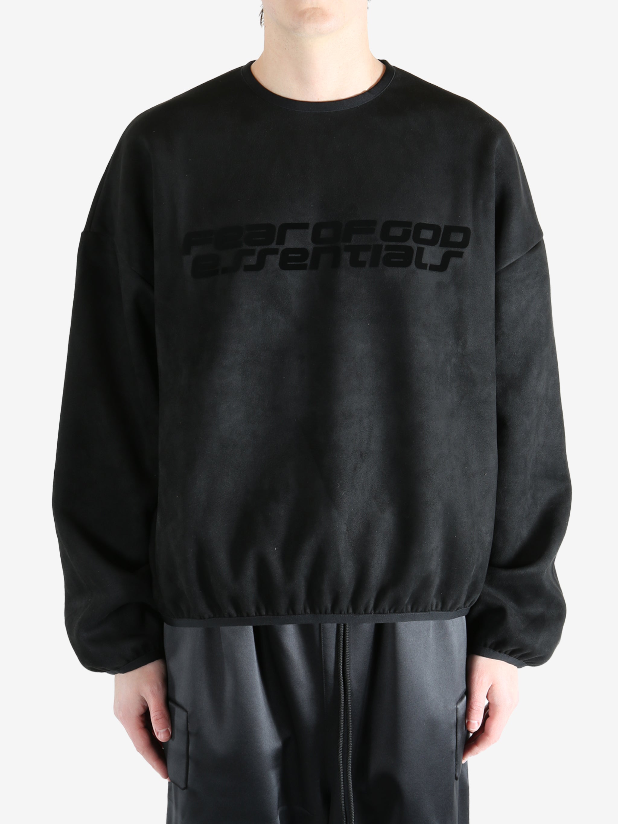 Black sweatshirt worn by a person, showing the sweatshirt's fit