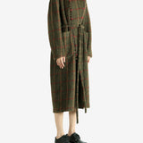 Green dress worn by a person, showing the dress fit