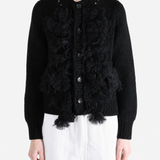 Black knitwear worn by a person, showing the knitwear fit