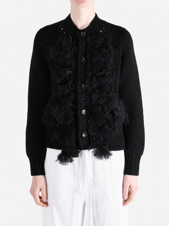 Black knitwear worn by a person, showing the knitwear fit