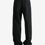 Black pants worn by a person, showing the pants fit