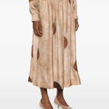 Tan skirt worn by a person, showing the skirt's fit