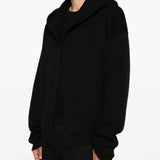 Black hoodie worn by a person, showing the hoodie fit