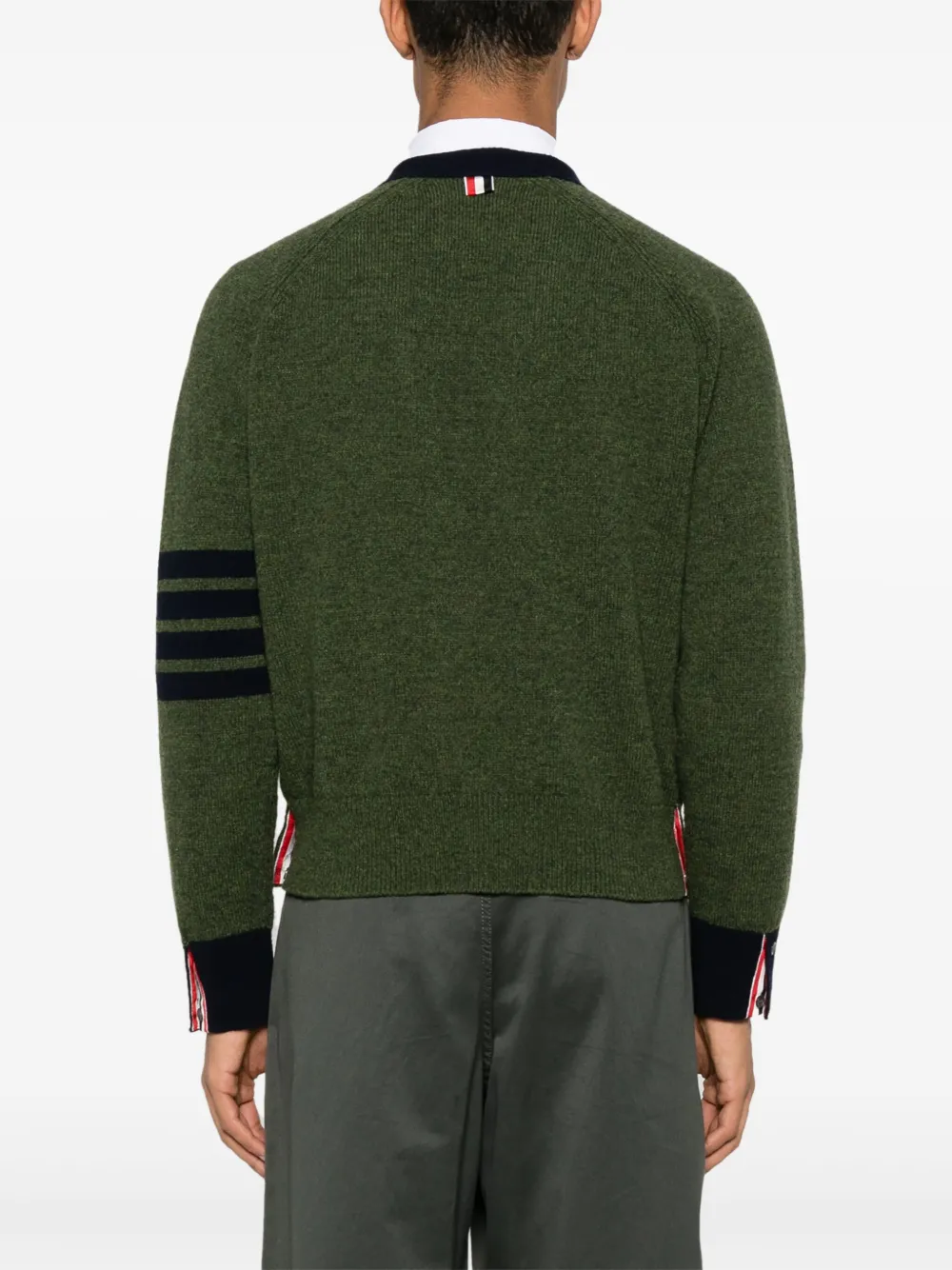 green knitwear worn by a person, showing the knitwear fit