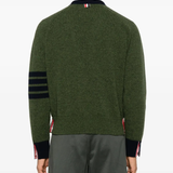 green knitwear worn by a person, showing the knitwear fit