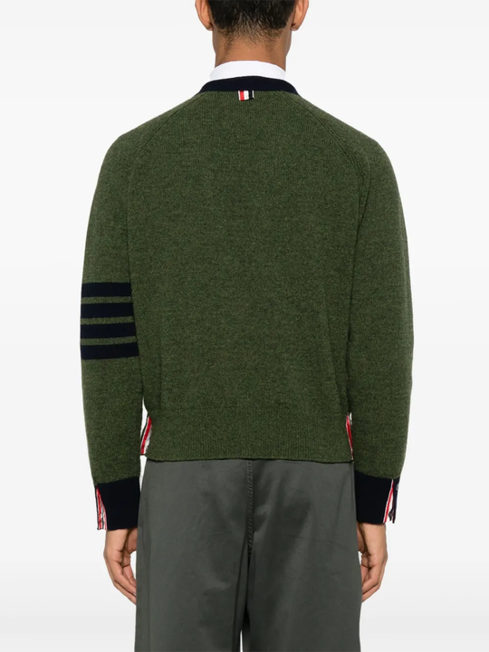 green knitwear worn by a person, showing the knitwear fit