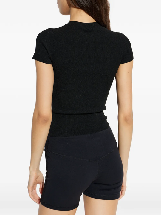 black top worn by a person, showing the top's fit