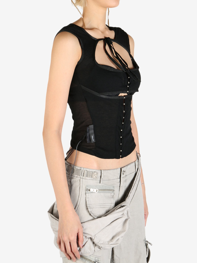 Black tops worn by a person, showing the tops's fit
