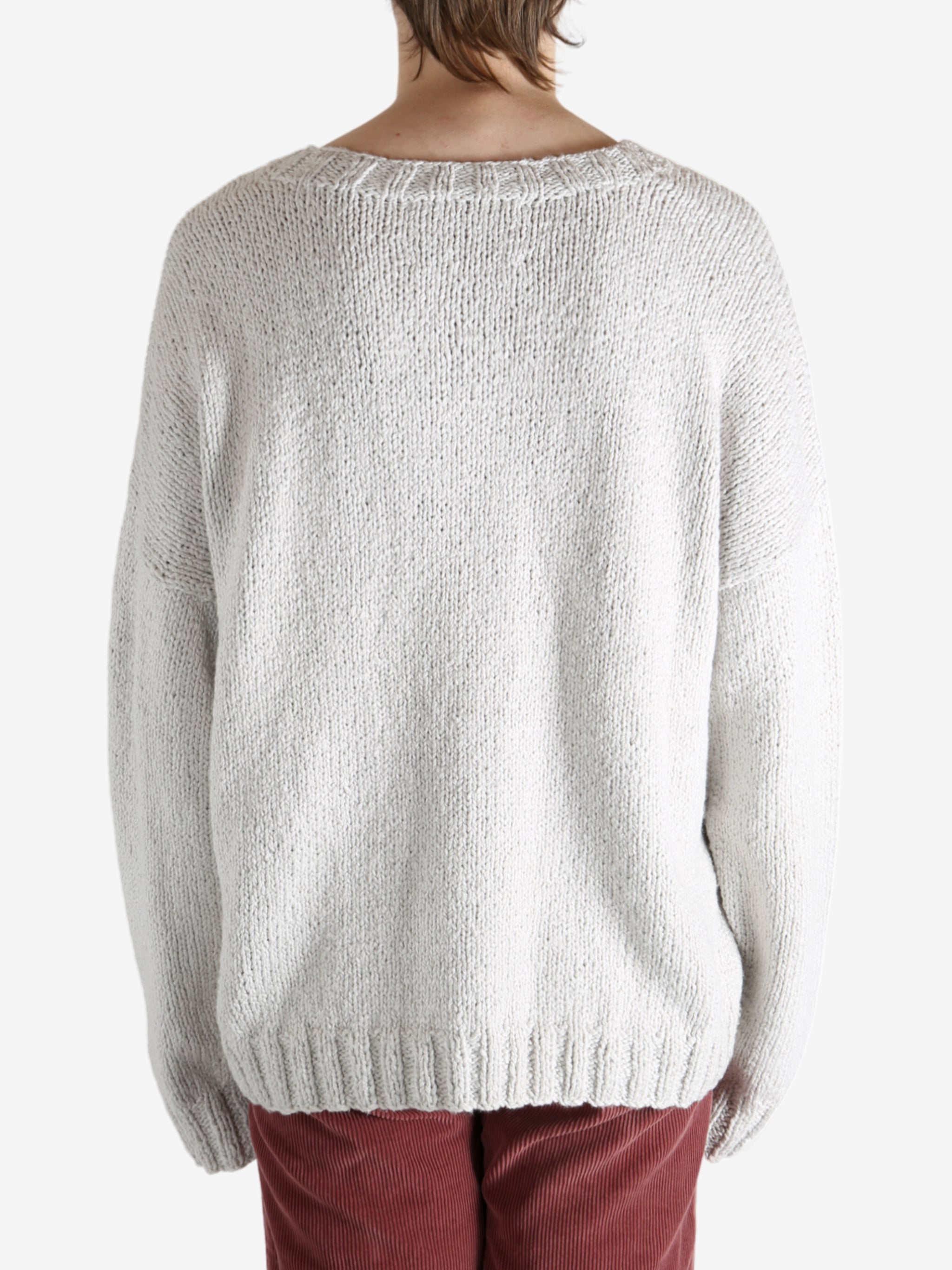 Grey sweater worn by a person, showing the sweater fit